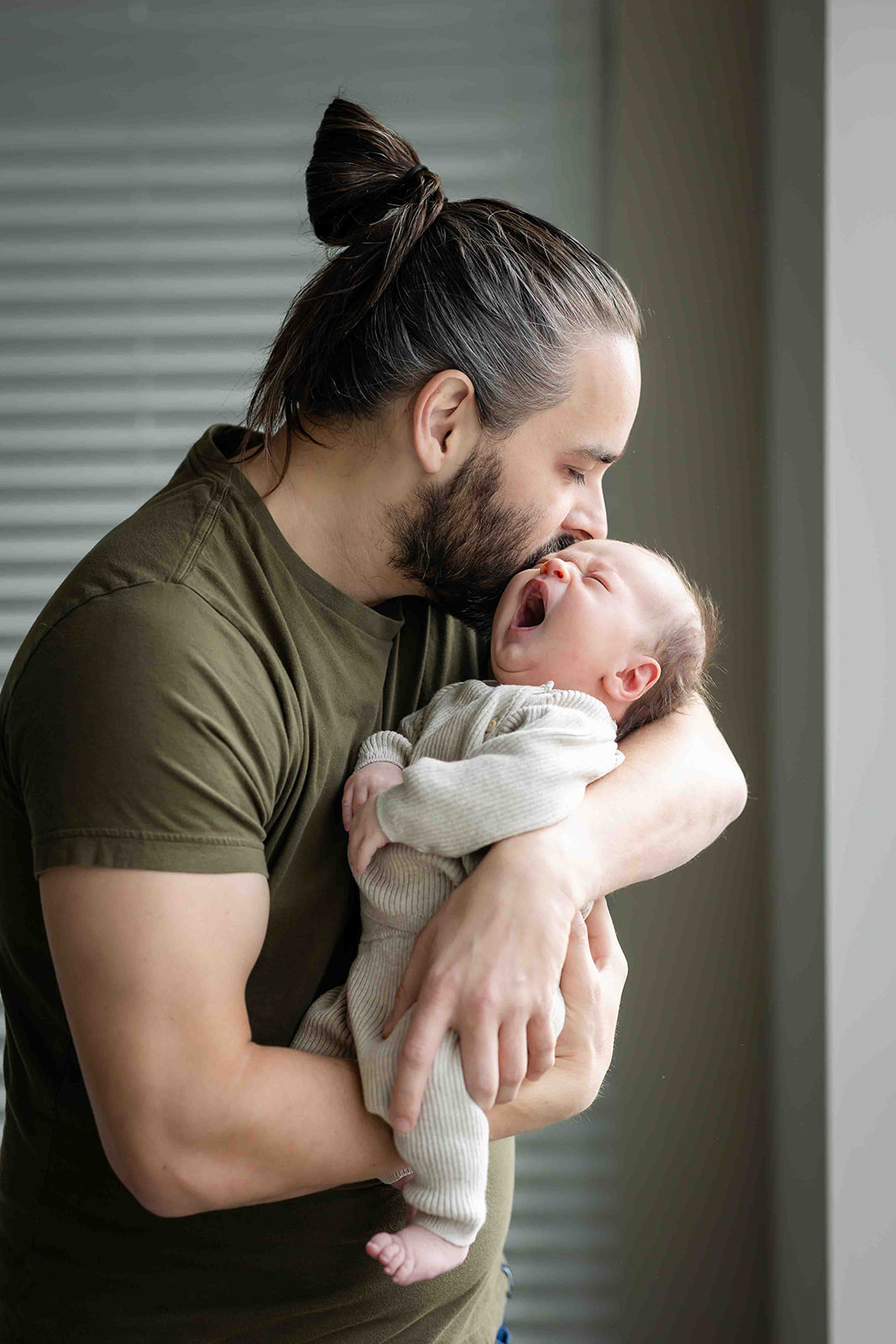 Dad holding newborn during newborn photography session