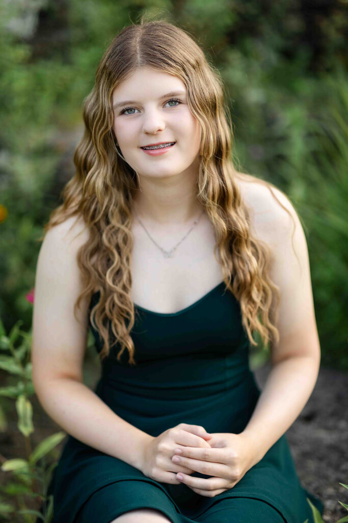 The soft lean is perfect for a warm, inviting portrait. Chloe absolutely nailed it surrounded by the garden blooms.