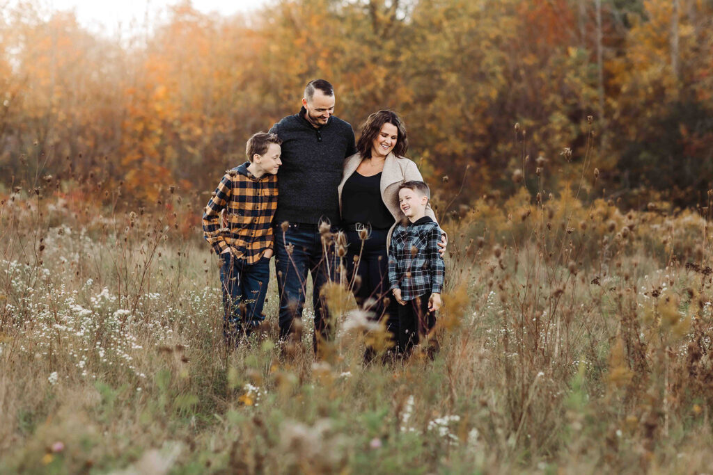 family with fall backdrop in field