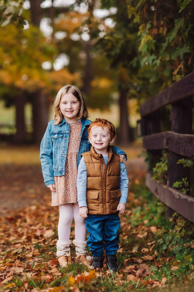 brother and sister in field of fall colours