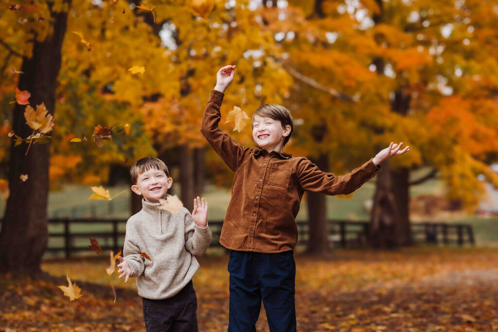 kids throwing leaves in fall photos