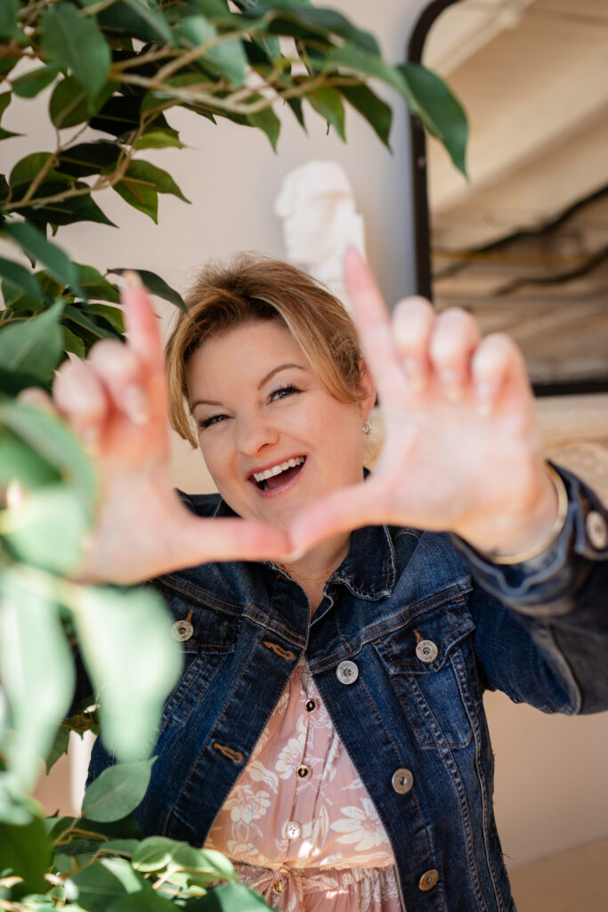 Kitchener-Waterloo branding photographer gesturing frame symbol with big smile