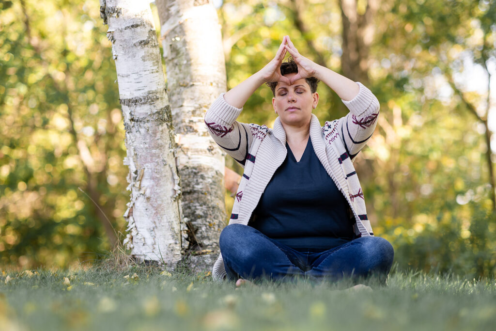 Natural outdoor brand portrait of Energetic Wealth founder Jill, meditating, photographed by Portraits by Kendra.