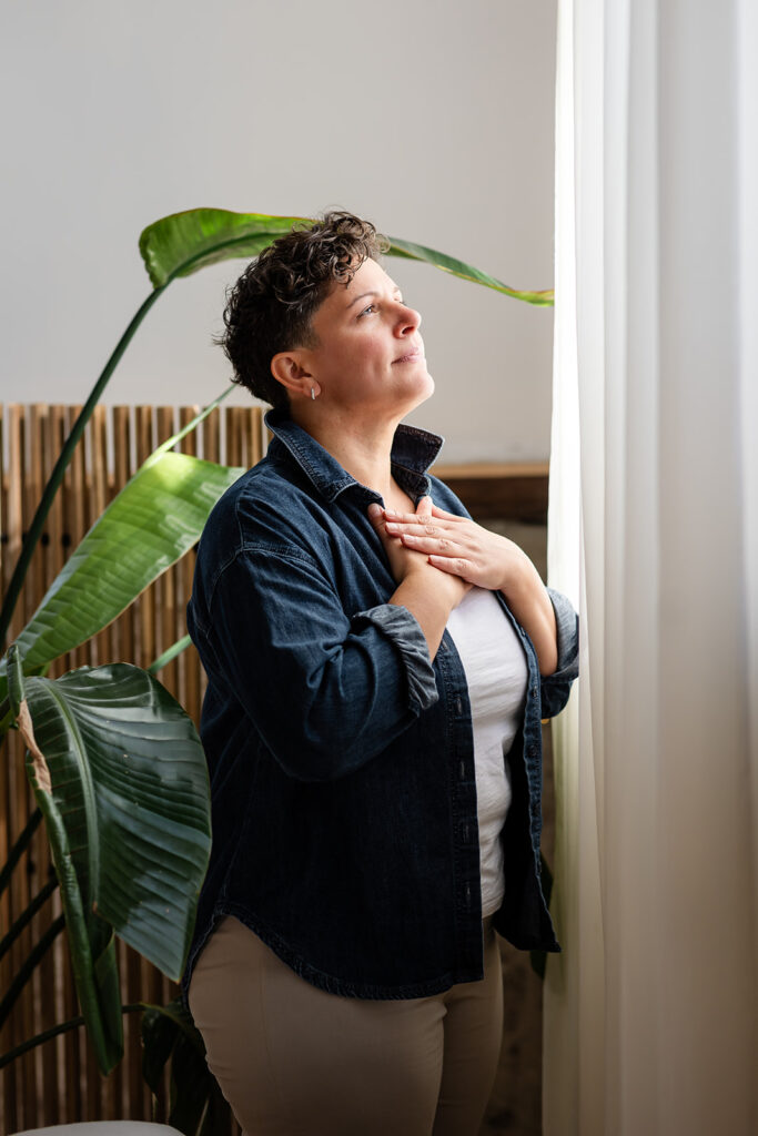 Energetic Wealth founder Jill demonstrating a calming EFT tapping routine during her Signature Brand Session with Portraits by Kendra in the KW area.