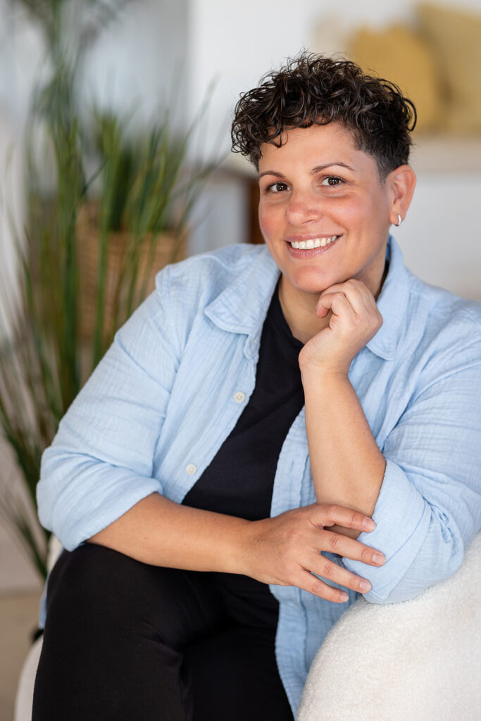 Jill smiling in the soft natural light at Sunroom Studios, photographed by Portraits by Kendra for her Energetic Wealth brand visuals.