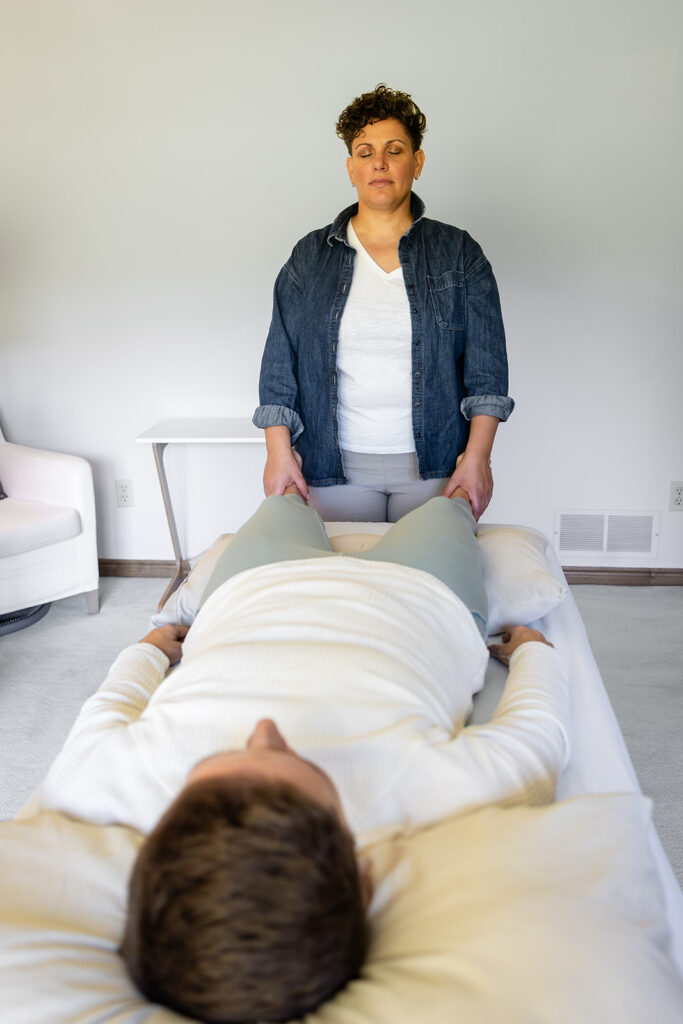 Jill working one-on-one with a client during an Energetic Wealth healing session, photographed by Portraits by Kendra in Kitchener-Waterloo.