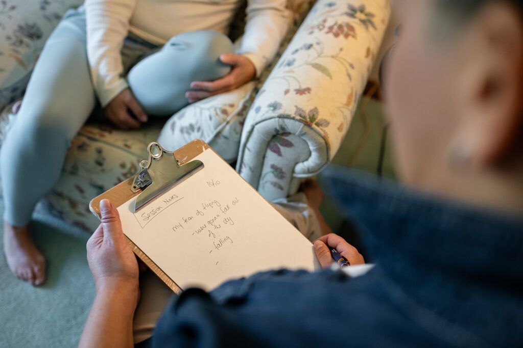 Jill working one-on-one with a client during an Energetic Wealth healing session, photographed by Portraits by Kendra in Kitchener-Waterloo.