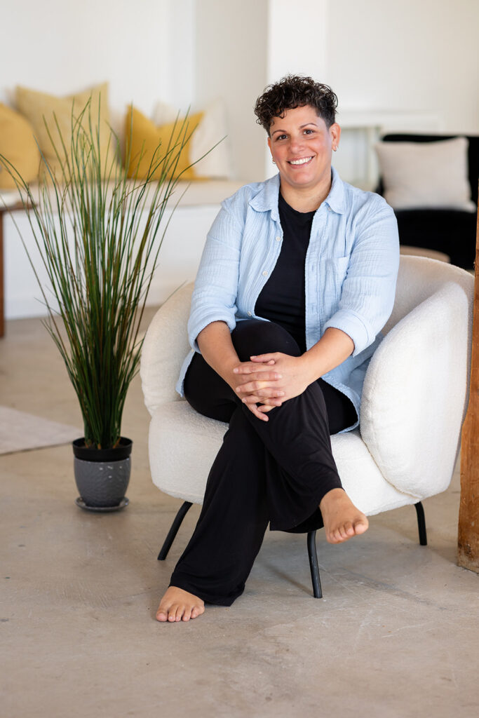Jill smiling in the soft natural light at Sunroom Studios, photographed by Portraits by Kendra for her Energetic Wealth brand visuals.