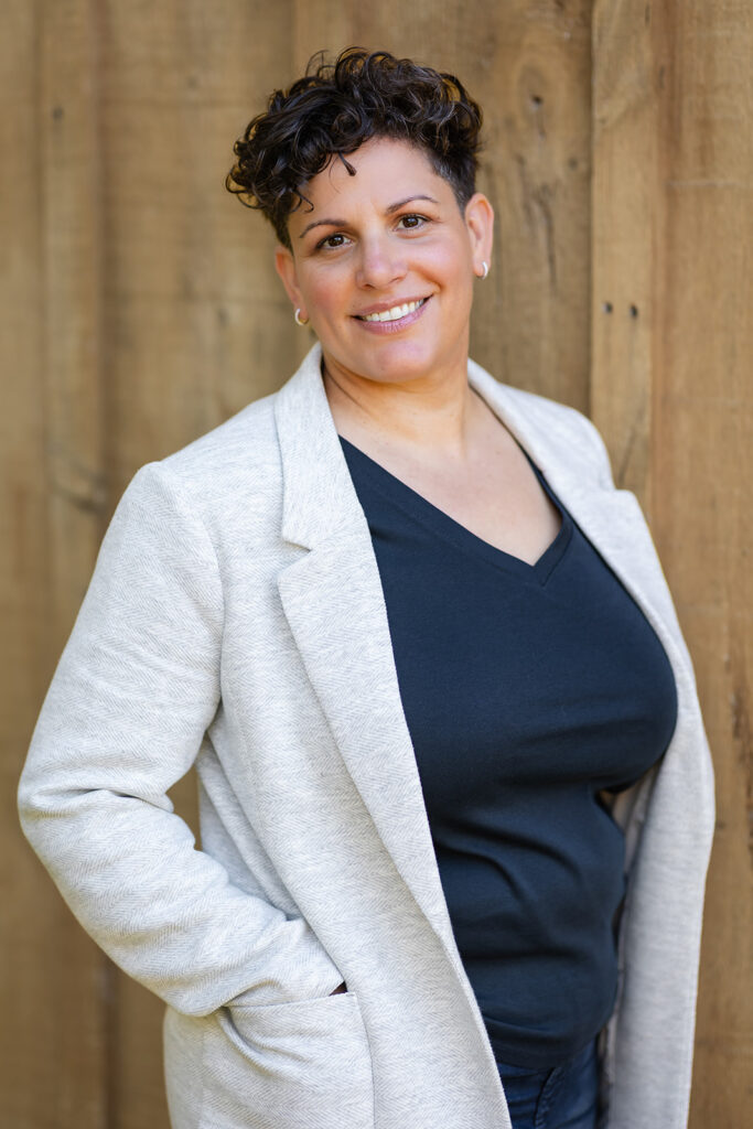 Jill smiling outdoors during her Signature Brand Session with Portraits by Kendra near KW, showcasing her warm and grounded energy.