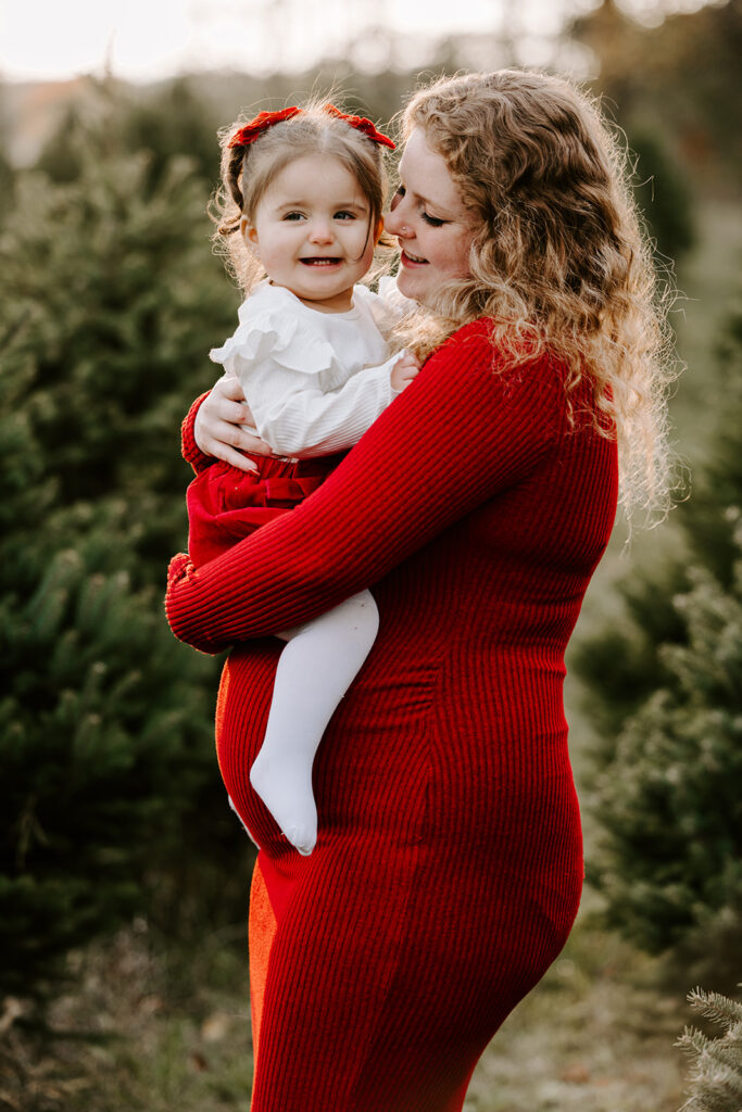 Holiday mini photo session at Chickadee Tree Farm featuring warm family moments among the Christmas trees — captured by Portraits by Kendra, Kitchener-Waterloo family photographer.