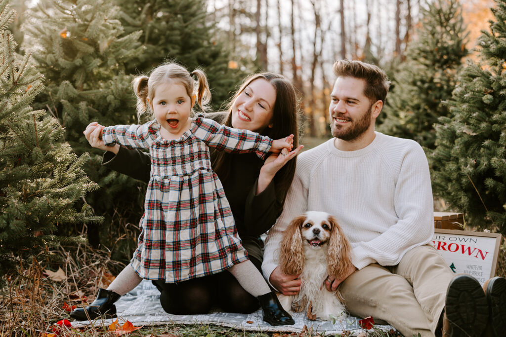Holiday mini photo session at Chickadee Tree Farm featuring warm family moments among the Christmas trees — captured by Portraits by Kendra, Kitchener-Waterloo family photographer.
