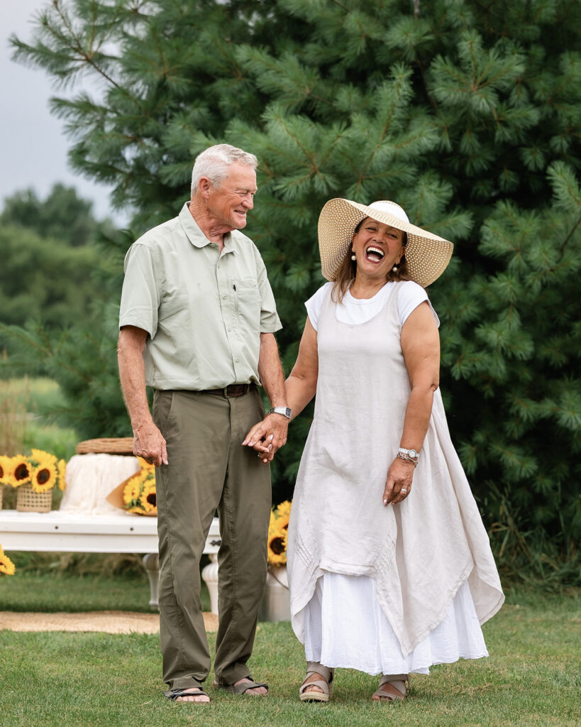 Joyful couple holding hands during an outdoor lifestyle photography session by Portraits by Kendra in Kitchener-Waterloo.