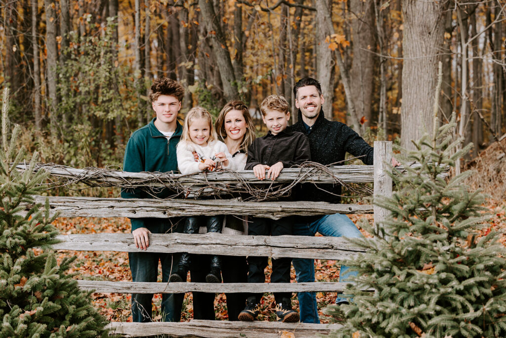 Holiday mini photo session at Chickadee Tree Farm featuring warm family moments among the Christmas trees — captured by Portraits by Kendra, Kitchener-Waterloo family photographer.