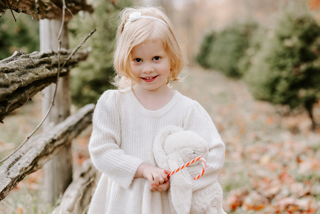 Holiday mini photo session at Chickadee Tree Farm featuring warm family moments among the Christmas trees — captured by Portraits by Kendra, Kitchener-Waterloo family photographer.