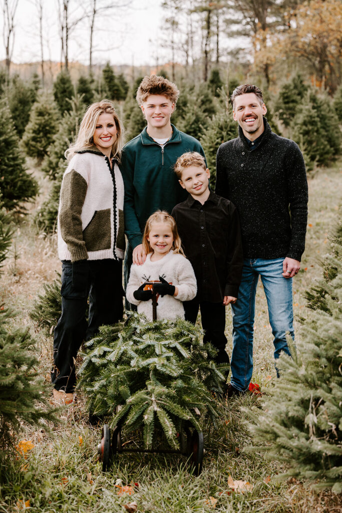 Holiday mini photo session at Chickadee Tree Farm featuring warm family moments among the Christmas trees — captured by Portraits by Kendra, Kitchener-Waterloo family photographer.