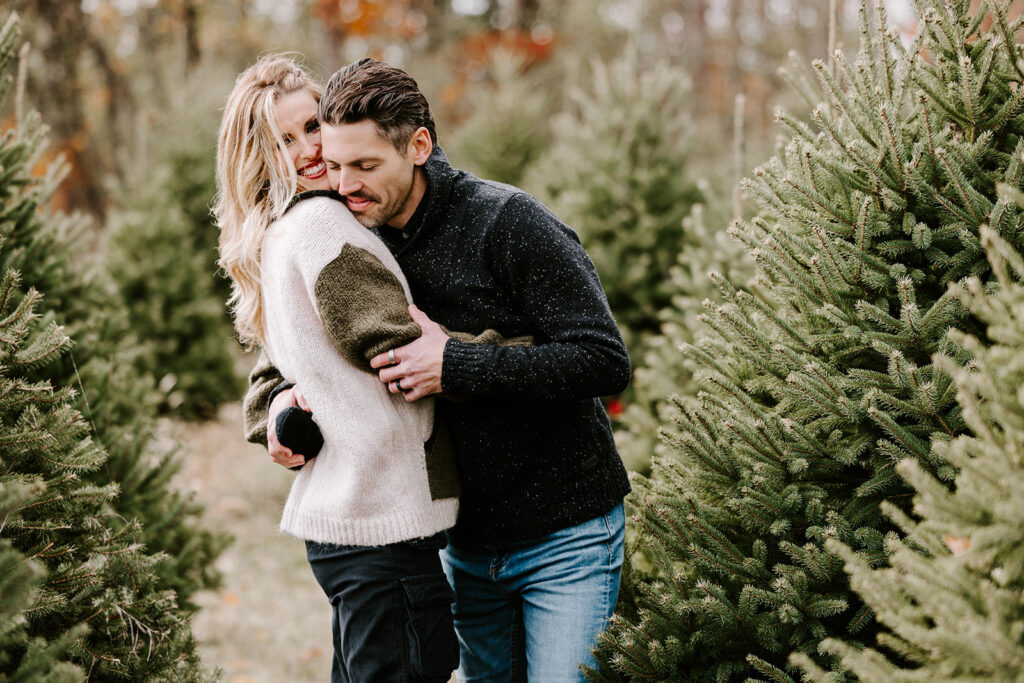 Holiday mini photo session at Chickadee Tree Farm featuring warm family moments among the Christmas trees — captured by Portraits by Kendra, Kitchener-Waterloo family photographer.