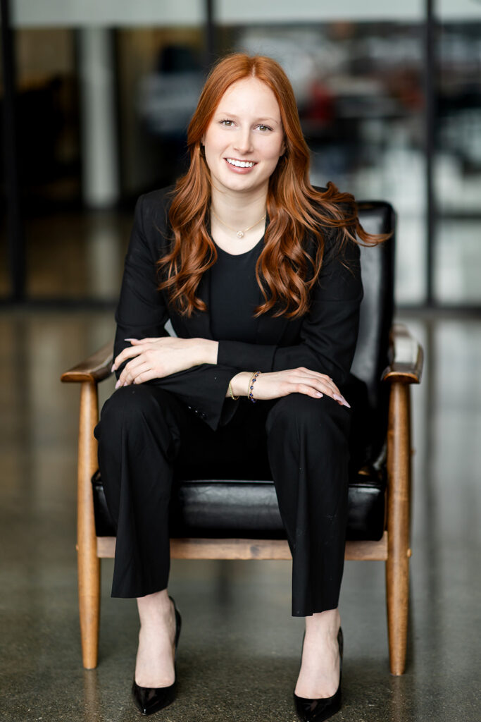 Professional headshot of Isabelle seated on a chair in studio in Kitchener-Waterloo, photographed by Portraits by Kendra.