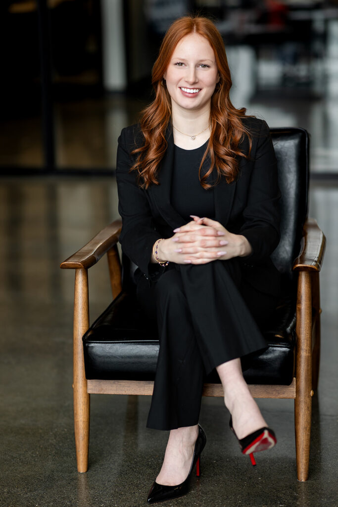 Professional headshot of Isabelle seated on a chair in studio in Kitchener-Waterloo, photographed by Portraits by Kendra.