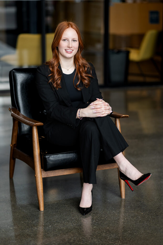 Professional headshot of Isabelle seated on a chair in studio in Kitchener-Waterloo, photographed by Portraits by Kendra.