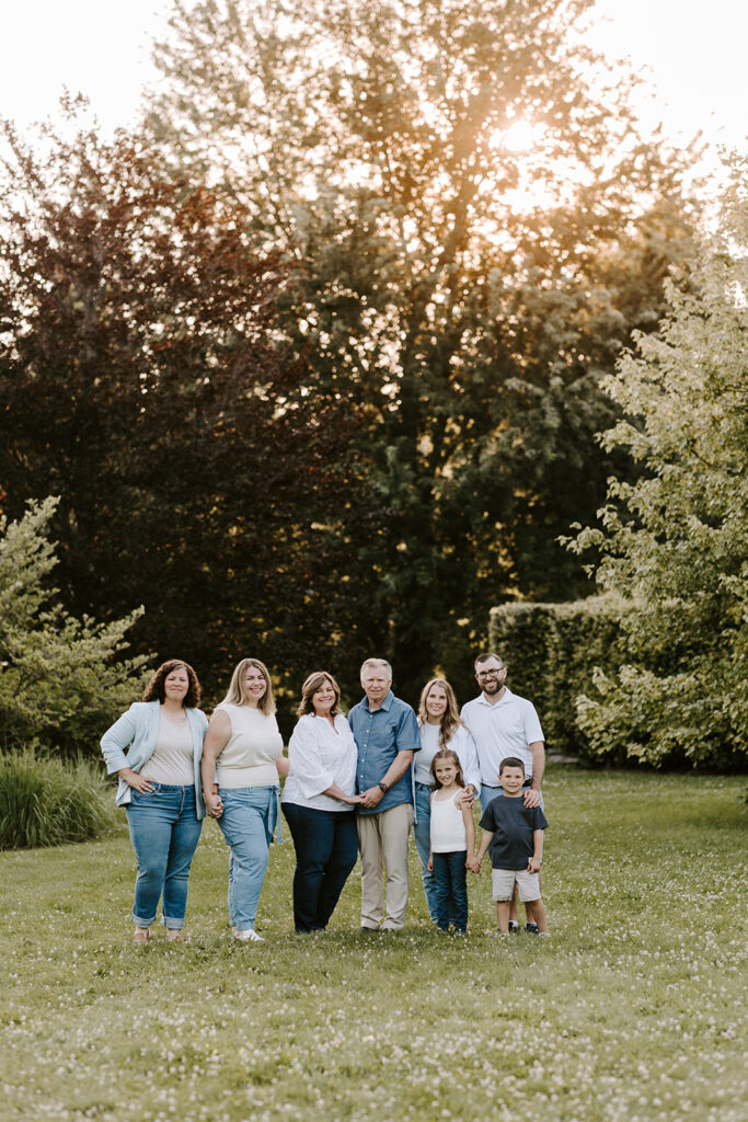 Outdoor photo of extended family taken at the Guelph Arboretum by Kitchener-Waterloo photographer, PortraitsByKendra