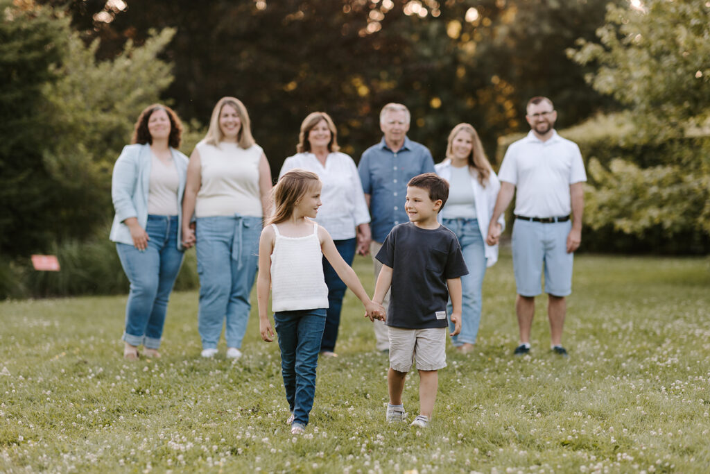 Outdoor photo of extended family taken at the Guelph Arboretum by Kitchener-Waterloo photographer, PortraitsByKendra