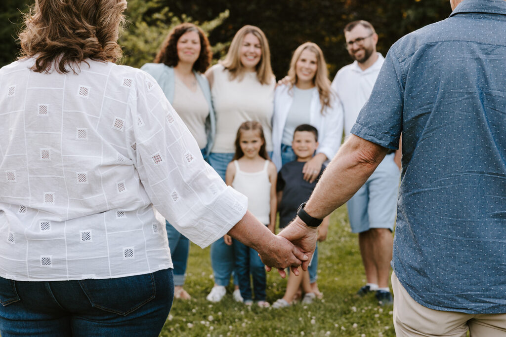 Outdoor photo of extended family taken at the Guelph Arboretum by Kitchener-Waterloo photographer, PortraitsByKendra