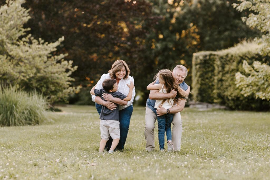 Photo of grandparents having fun with grandchildren outside at the Guelph Arboretum by Kitchener-Waterloo photographer, PortraitsByKendra