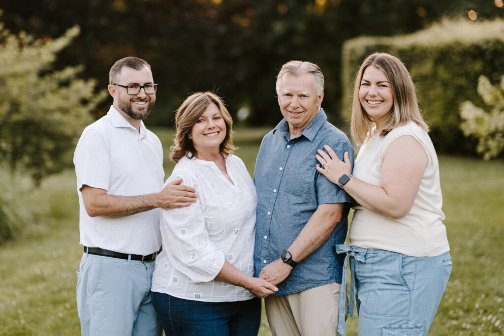 Outdoor photo of brother and sister with parents taken at the Guelph Arboretum by Kitchener-Waterloo photographer, PortraitsByKendra