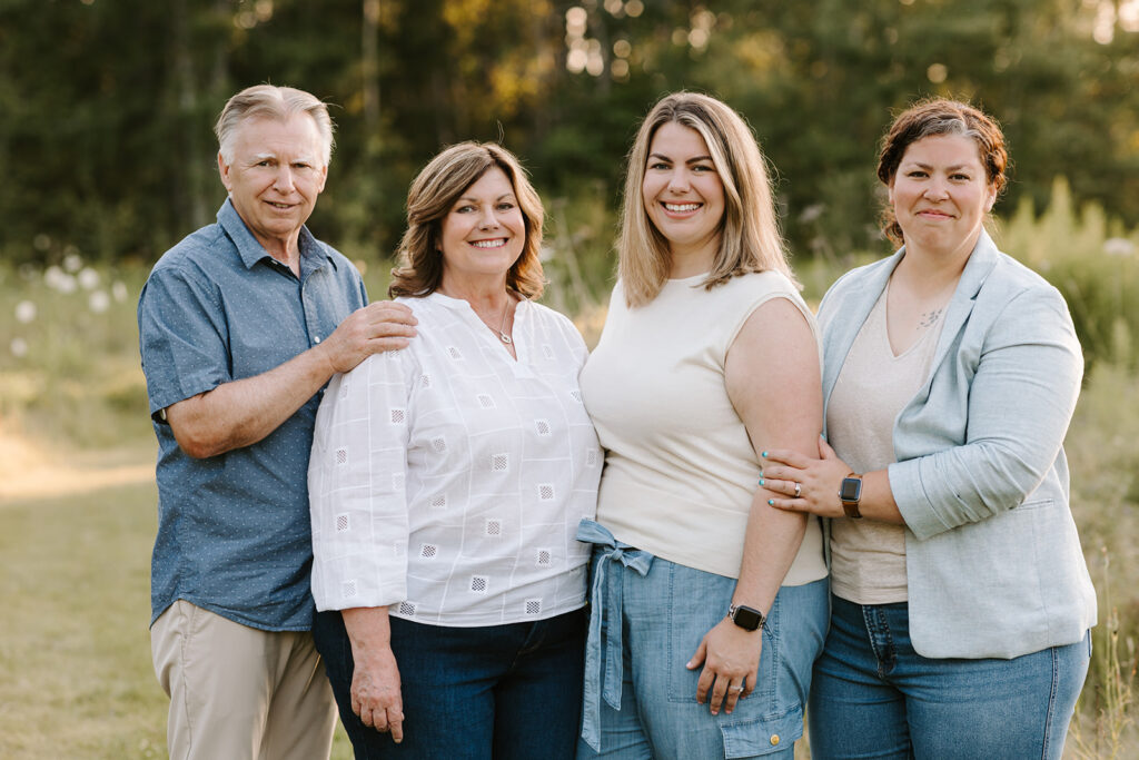 Outdoor photo of extended family taken at the Guelph Arboretum by Kitchener-Waterloo photographer, PortraitsByKendra