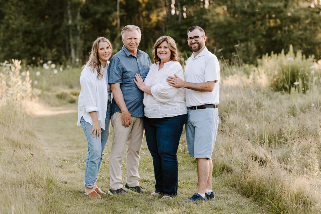 Outdoor photo of extended family taken at the Guelph Arboretum by Kitchener-Waterloo photographer, PortraitsByKendra