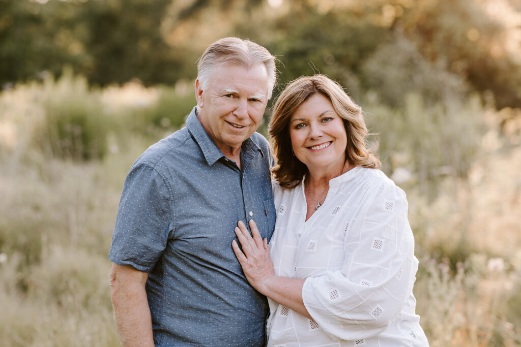 Outdoor photo of older couple taken at the Guelph Arboretum by Kitchener-Waterloo photographer, PortraitsByKendra