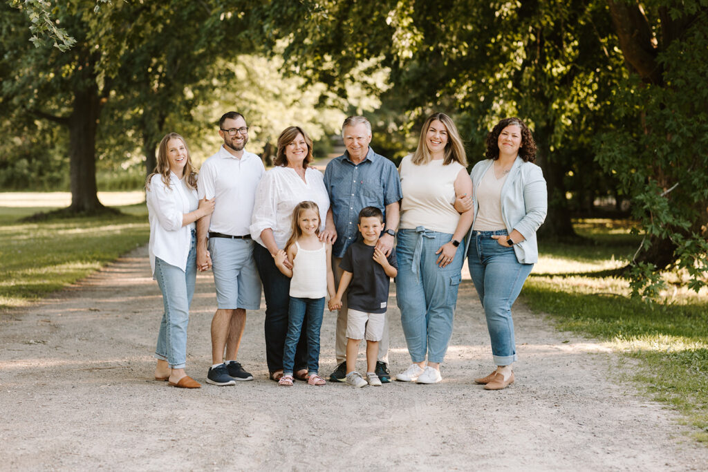 Outdoor photo of extended family taken at the Guelph Arboretum by Kitchener-Waterloo photographer, PortraitsByKendra