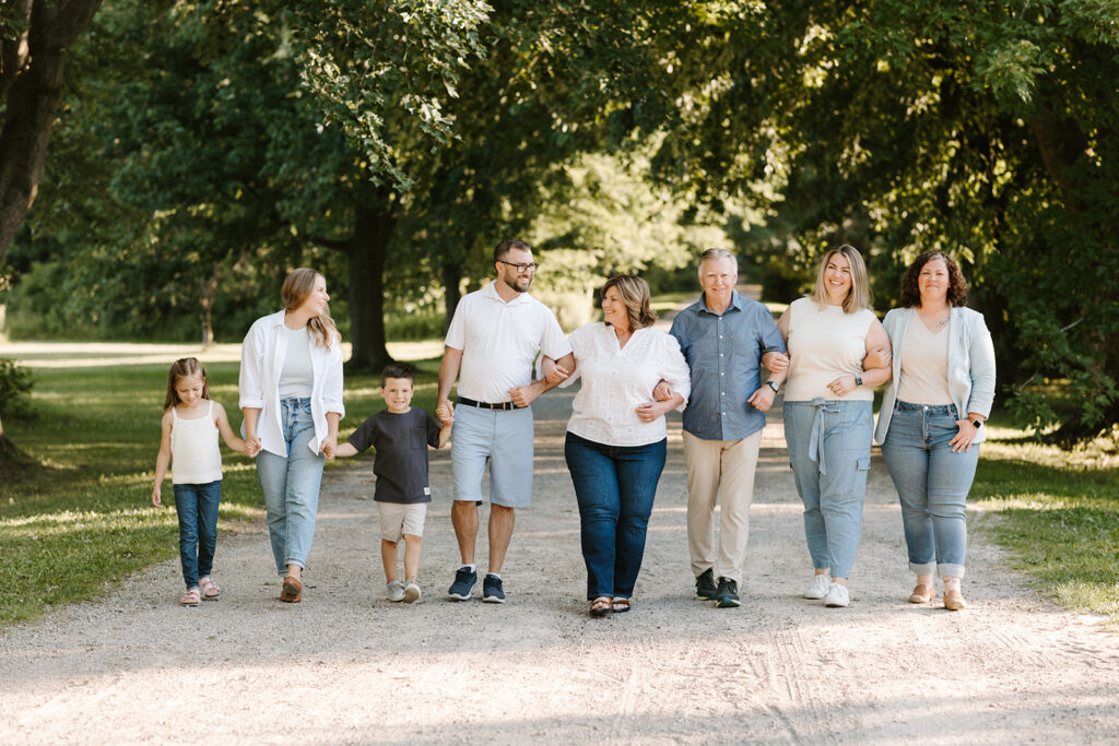 Outdoor photo of extended family taken at the Guelph Arboretum by Kitchener-Waterloo photographer, PortraitsByKendra
