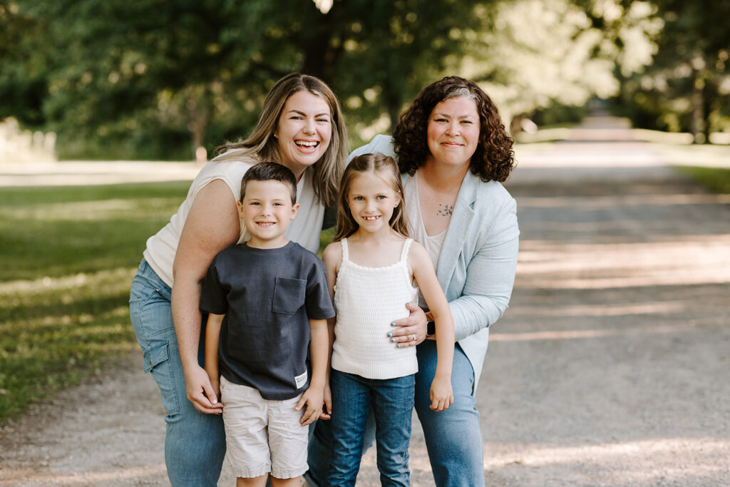 Outdoor photo of aunts with their niece and nephew taken at the Guelph Arboretum by Kitchener-Waterloo photographer, PortraitsByKendra