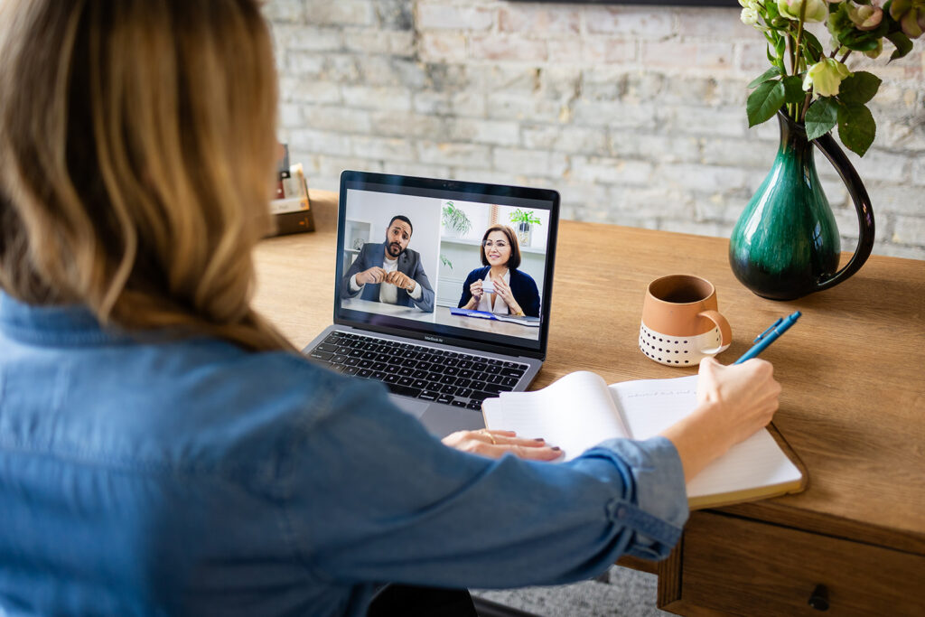 Image from a branding session showing an entrepreneur working at a desk or chatting with a client. Photo taken by Portraits by Kendra

