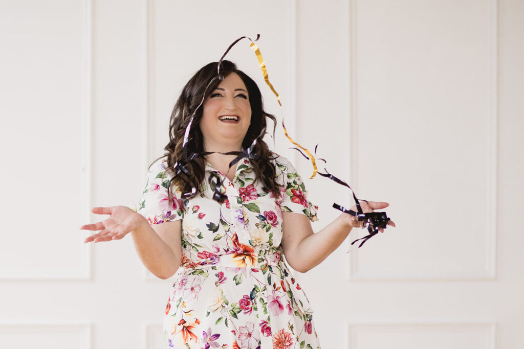 Mary Tchabrazian, owner of Marycuterie, throwing confetti during a branding photoshoot by Portraits by Kendra in Waterloo Region