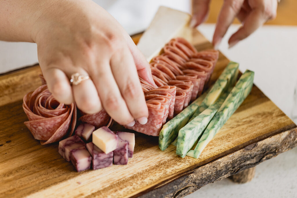 Mary Tchabrazian, owner of Marycuterie, creating a charcuterie board during a branding photoshoot by Portraits by Kendra in Waterloo Region