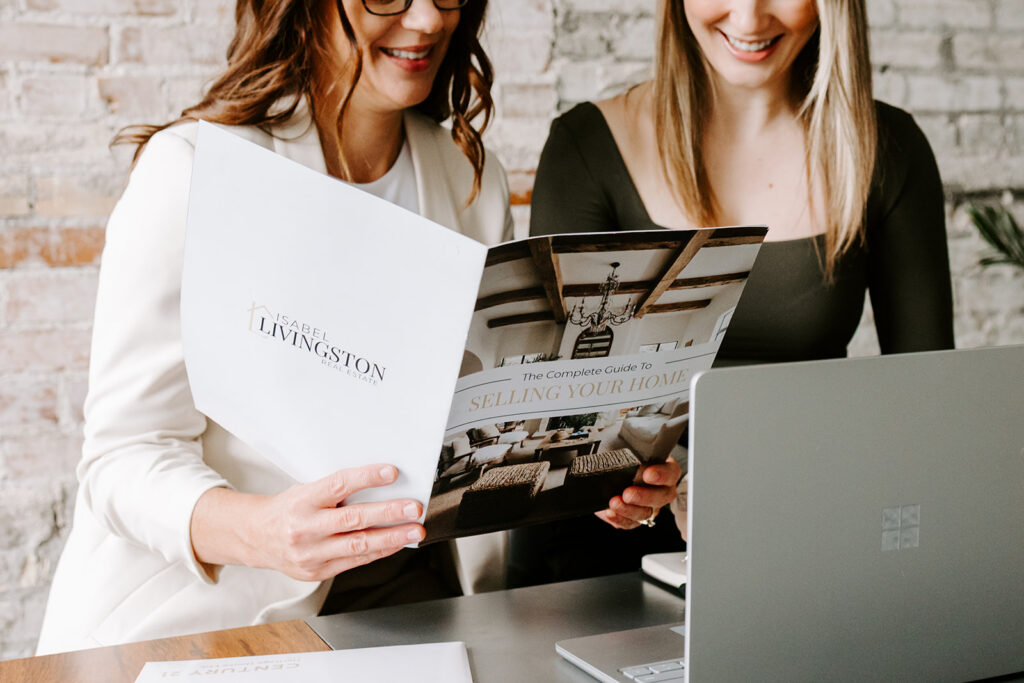 Photo of the The Livingston Team reading a report during a Mother-Daughter Branding Session at West Haus Studio in Downtown Kitchener, taken by Portraits by Kendra