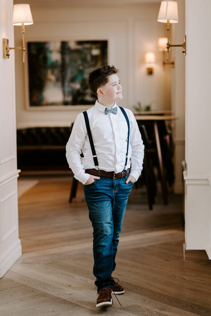 A teen boy walking inside. Photo taken by by Portraits by Kendra in Kitchener-Waterloo