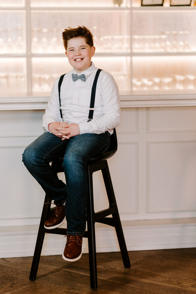 Birthday portrait of a smiling teen boy sitting on a chair—photo taken in Kitchener-Waterloo by Portraits Portrait by Kendra.