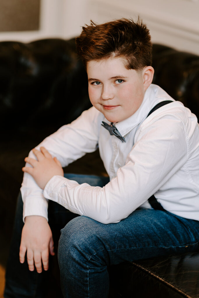 Teen boy sitting on couch for a birthday portrait taken by Portraits by Kendra in Kitchener-Waterloo