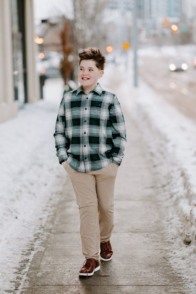 A teen boy walking outdoors. Photo taken  by Portraits by Kendra in Kitchener-Waterloo