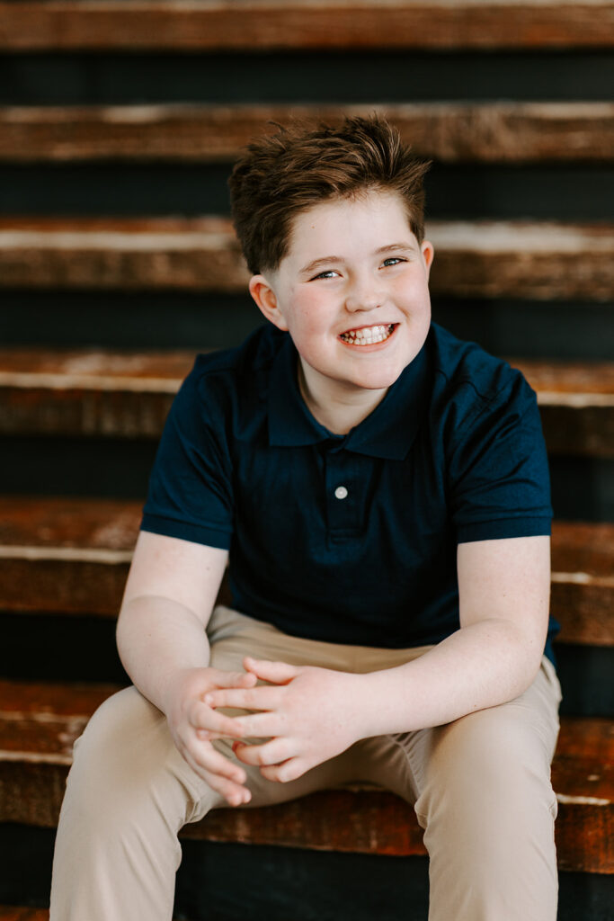 Teen boy birthday portrait sitting on stairs in Kitchener-Waterloo by Portraits by Kendra