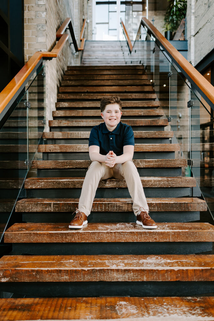 Teen boy birthday portrait sitting on stairs in Kitchener-Waterloo by Portraits by Kendra
