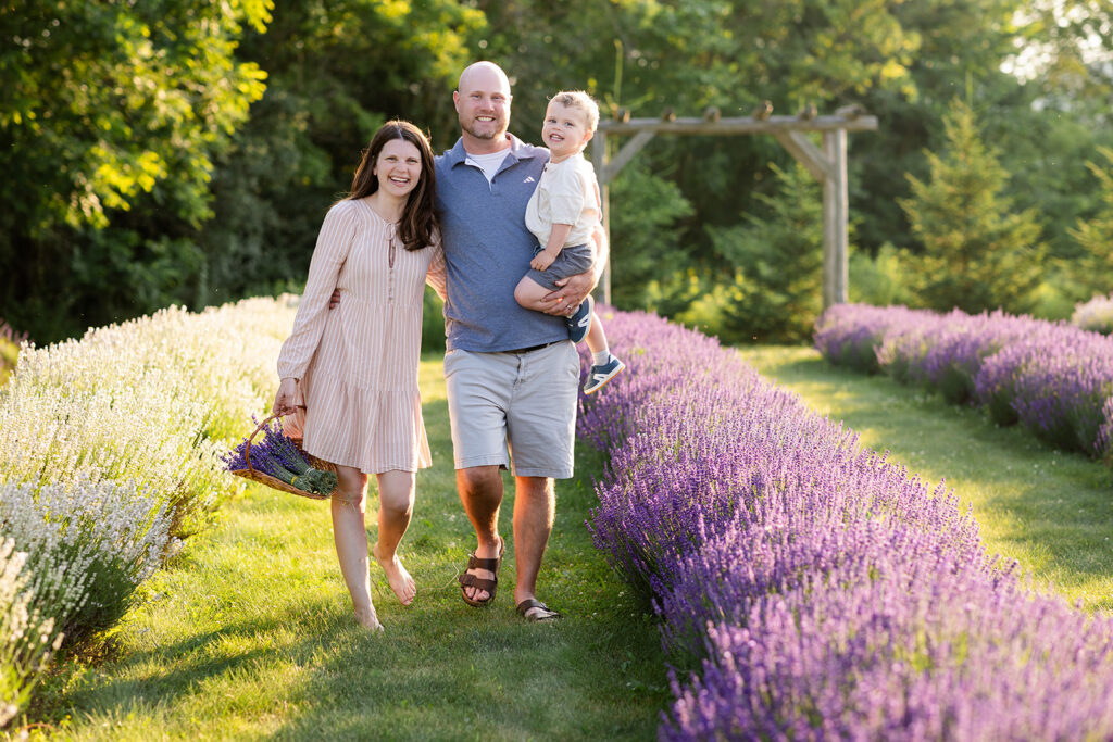 Photo of a family standingin a lavender field taken by Portraits by Kendra Photography in Kitchener-Waterloo during her Golden Hour in the Lavender Felds Limited Edition Session