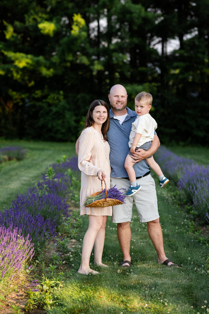 Photo of a family standingin a lavender field taken by Portraits by Kendra Photography in Kitchener-Waterloo during her Golden Hour in the Lavender Felds Limited Edition Session
