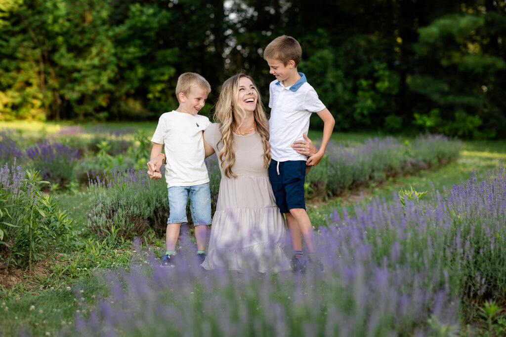 Photo of a a mother and her two sons in a lavender field taken by Portraits by Kendra Photography in Kitchener-Waterloo during her Golden Hour in the Lavender Felds Limited Edition Session