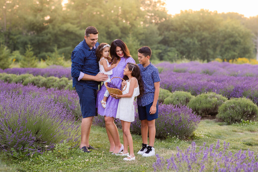 Photo of a family standing in a lavender field taken by Portraits by Kendra Photography in Kitchener-Waterloo during her Golden Hour in the Lavender Felds Limited Edition Session