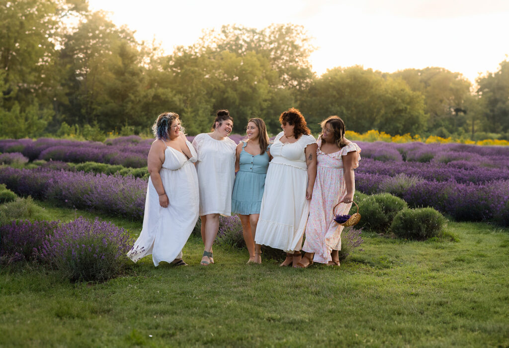 Photo of a five young ladies standng in a lavender field taken by Portraits by Kendra Photography in Kitchener-Waterloo during her Golden Hour in the Lavender Felds Limited Edition Session