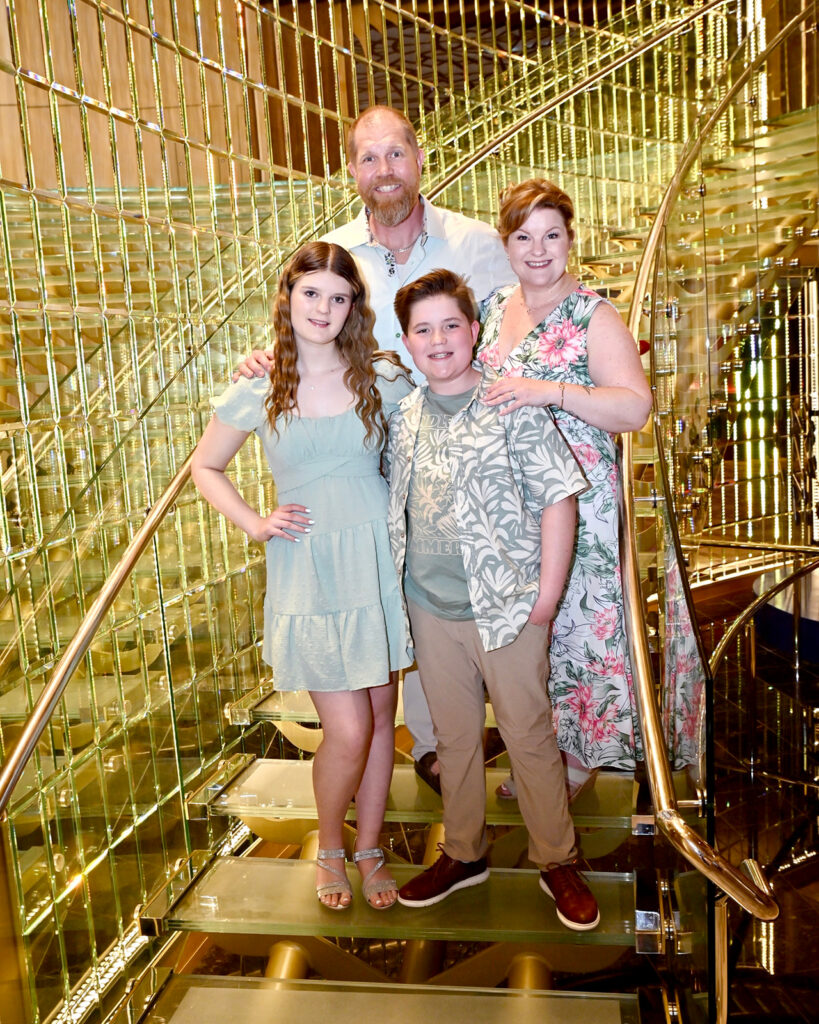 Photo of Kendra of Portraits by Kendra and her family taken on staircase on board a Carnival cruise vacation